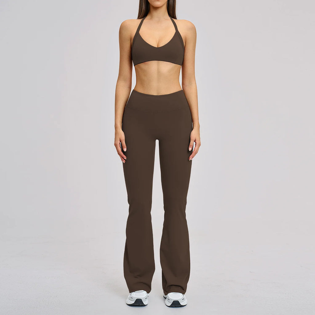 Woman wearing a brown sports bra and leggings set on a gray background