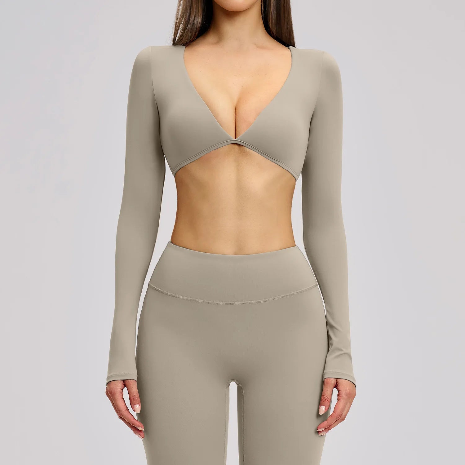 Beige long-sleeve top and leggings set on a plain background