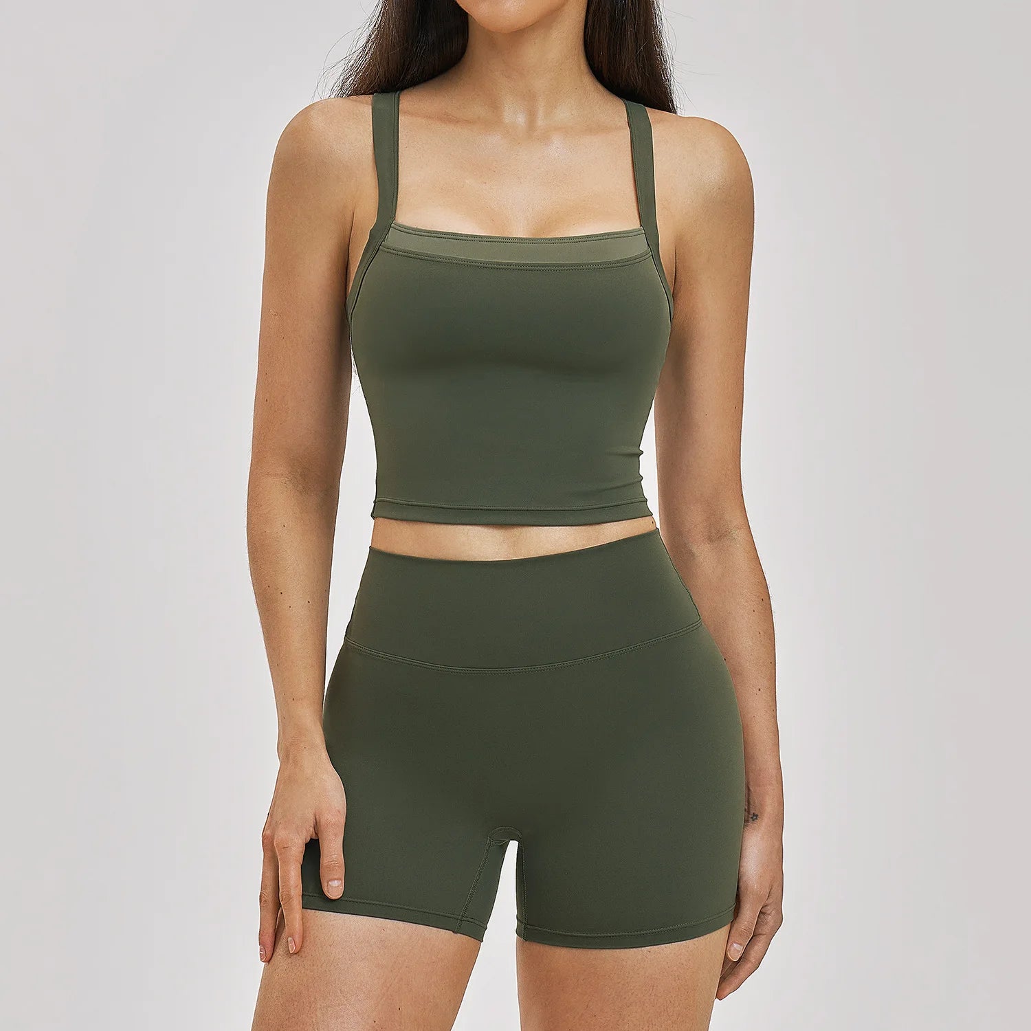 Person wearing a green athletic outfit on a white background