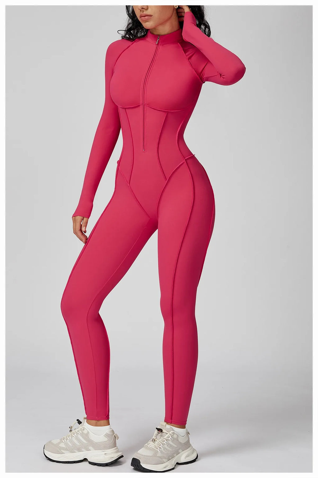 Person wearing a pink jumpsuit on a gray background