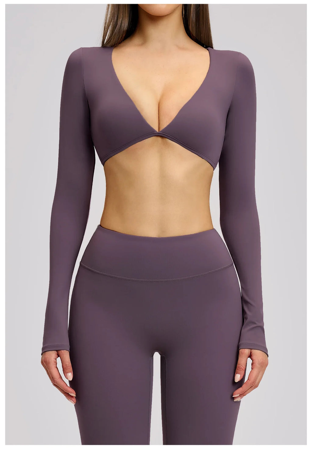 Purple long-sleeve athletic top and leggings on a plain background