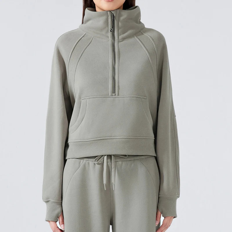 Person wearing a gray tracksuit on a light gray background