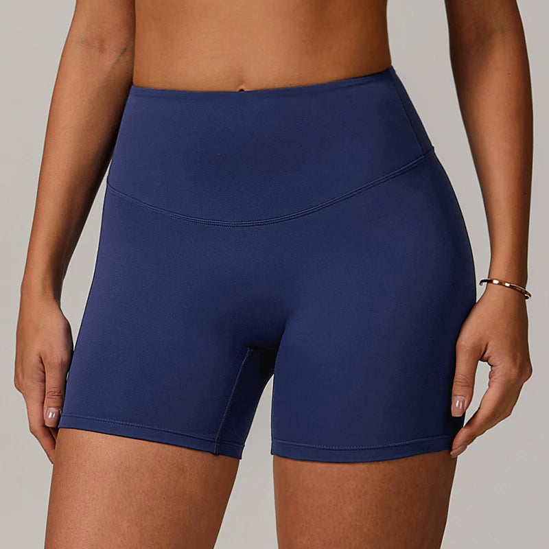 Person wearing blue athletic shorts on a plain background