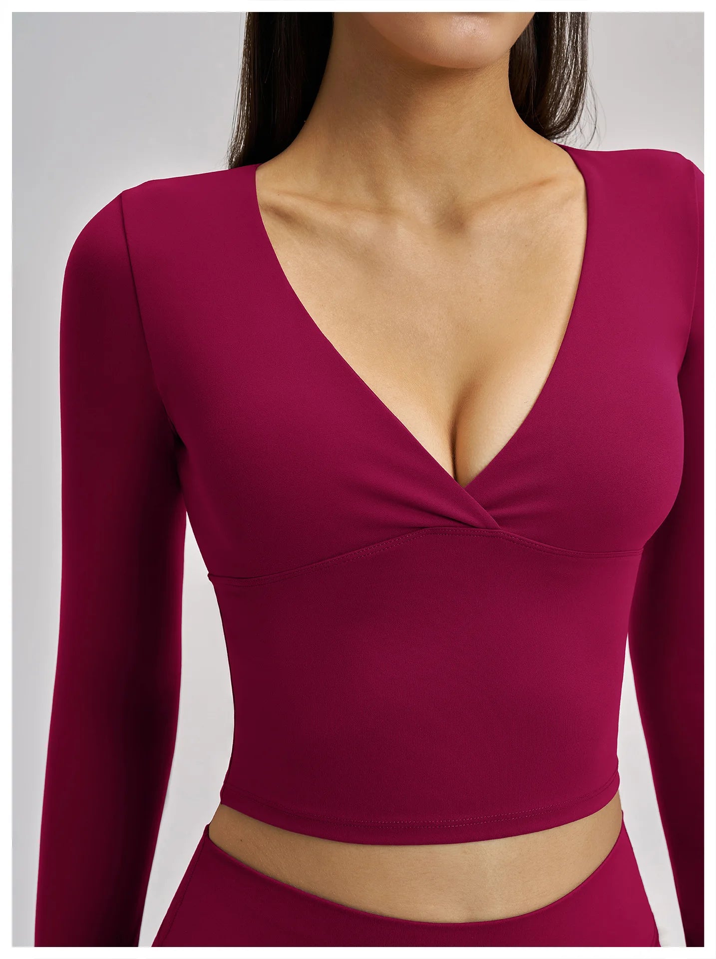 Maroon long-sleeve top worn by a model on a plain background