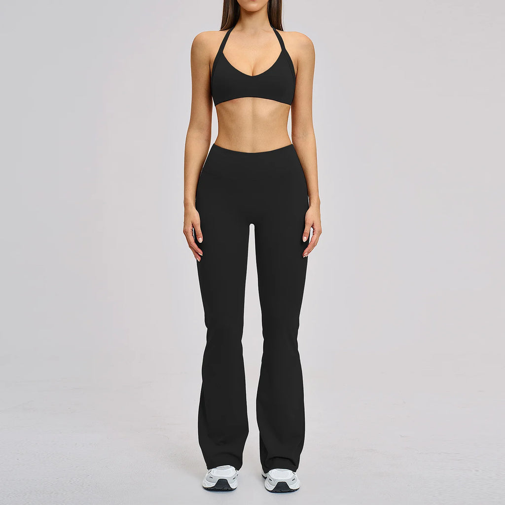 Person wearing a black sports bra and leggings on a gray background