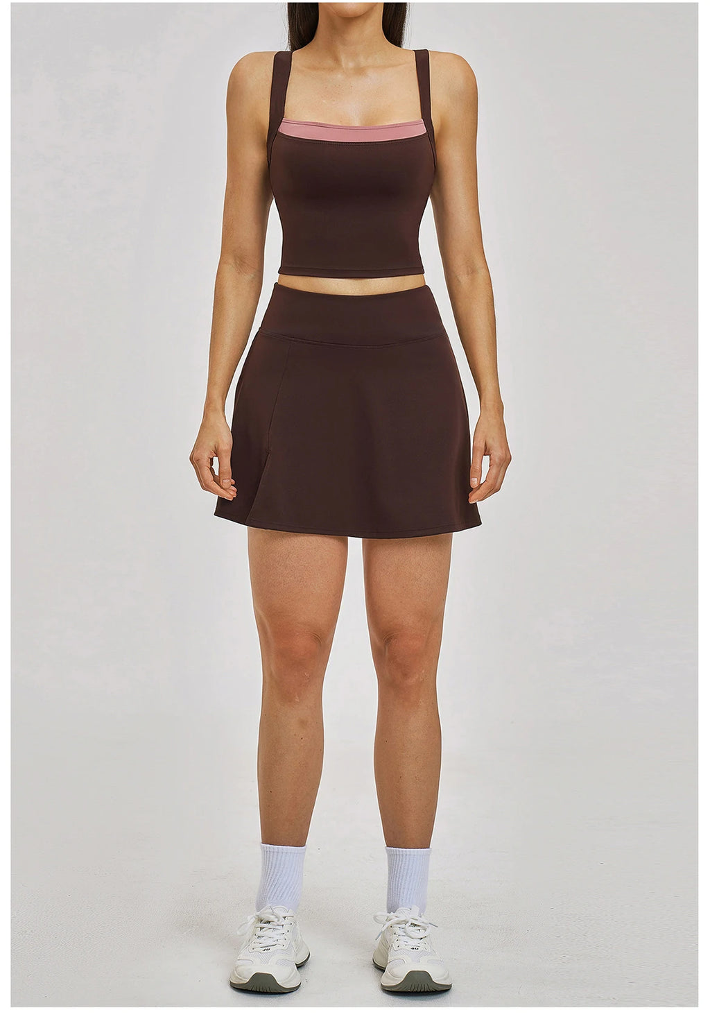 Person wearing a brown athletic outfit on a plain background