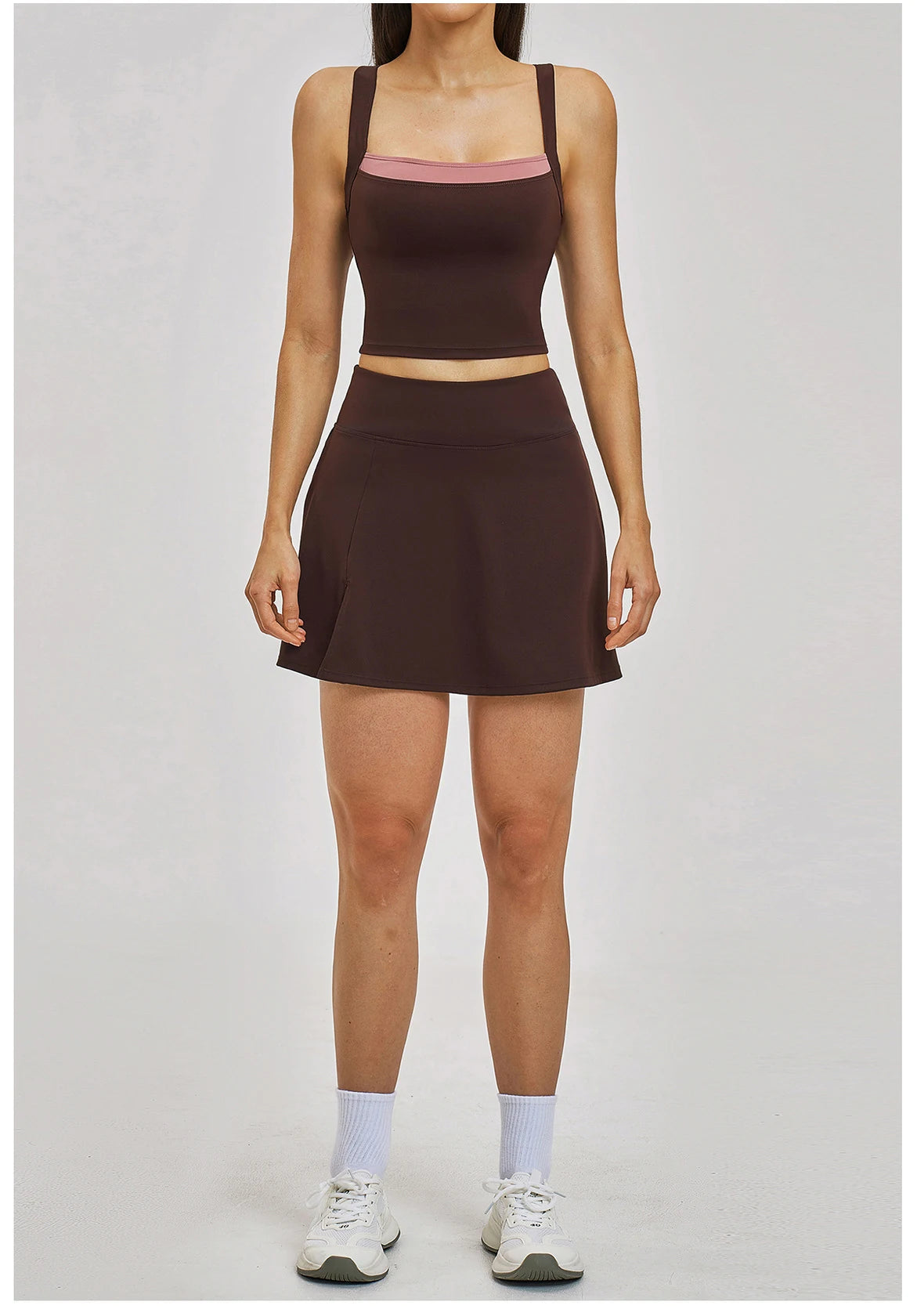Person wearing a brown athletic outfit on a plain background