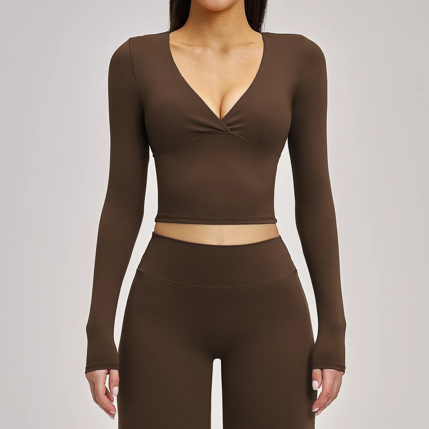 Brown long-sleeve top and leggings set on a plain background