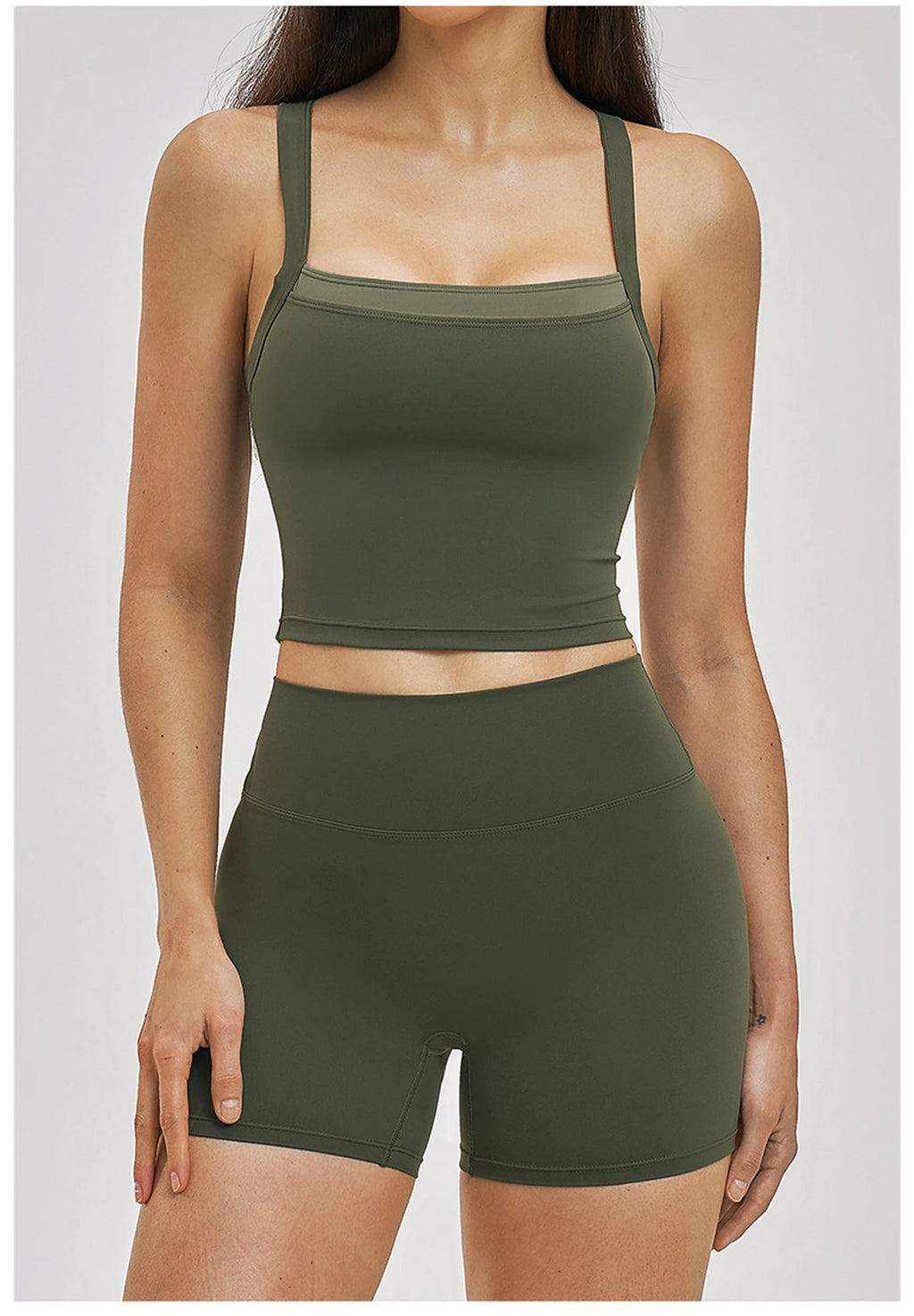 Person wearing a green sports bra and shorts set on a white background