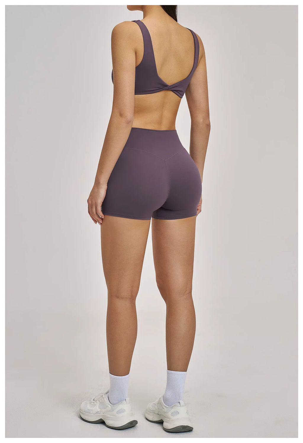 Person wearing a purple athletic outfit on a plain background