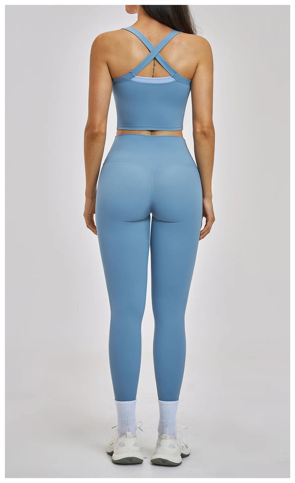 Person wearing a blue athletic outfit on a gray background
