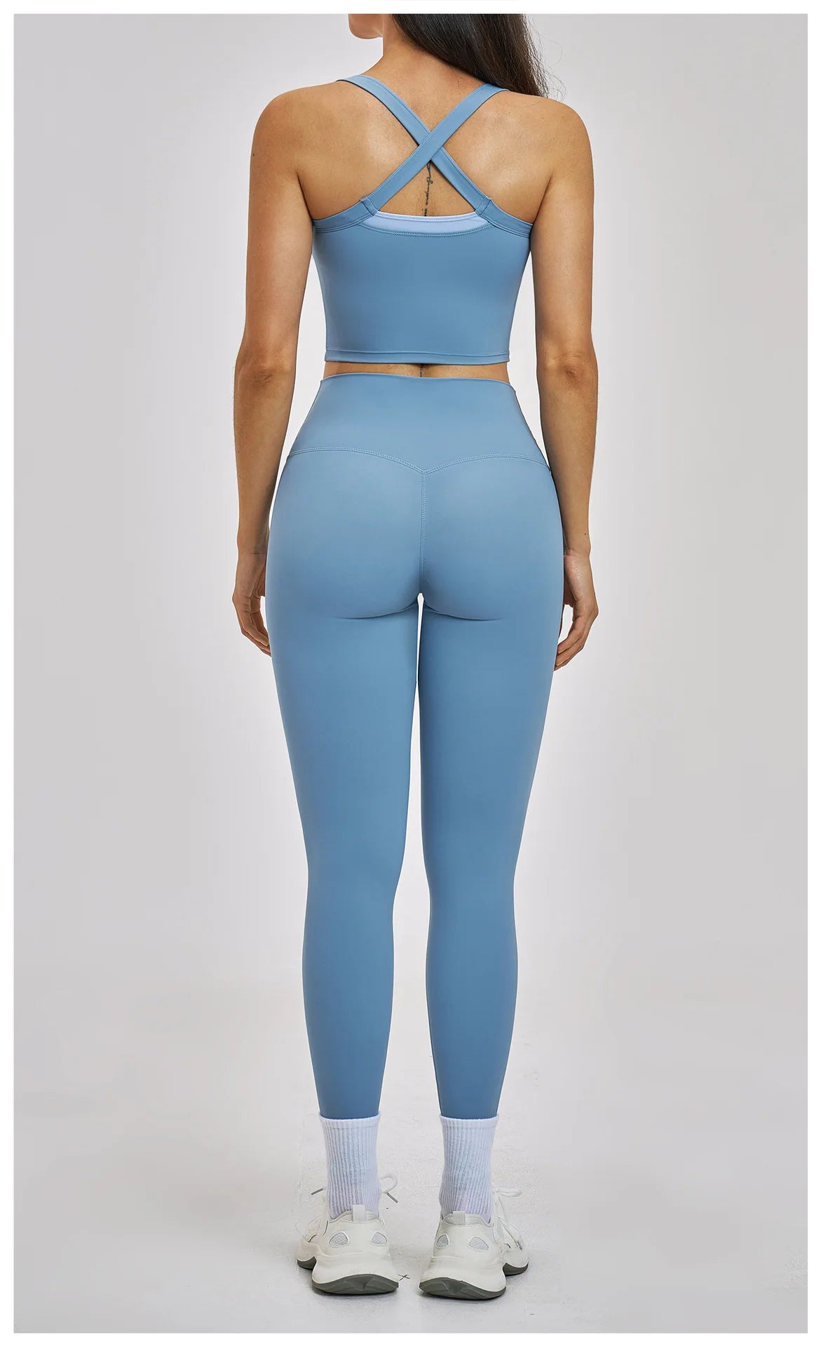 Person wearing a blue athletic outfit on a gray background