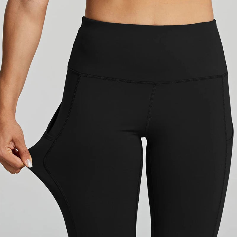 Black leggings worn by a person on a gray background