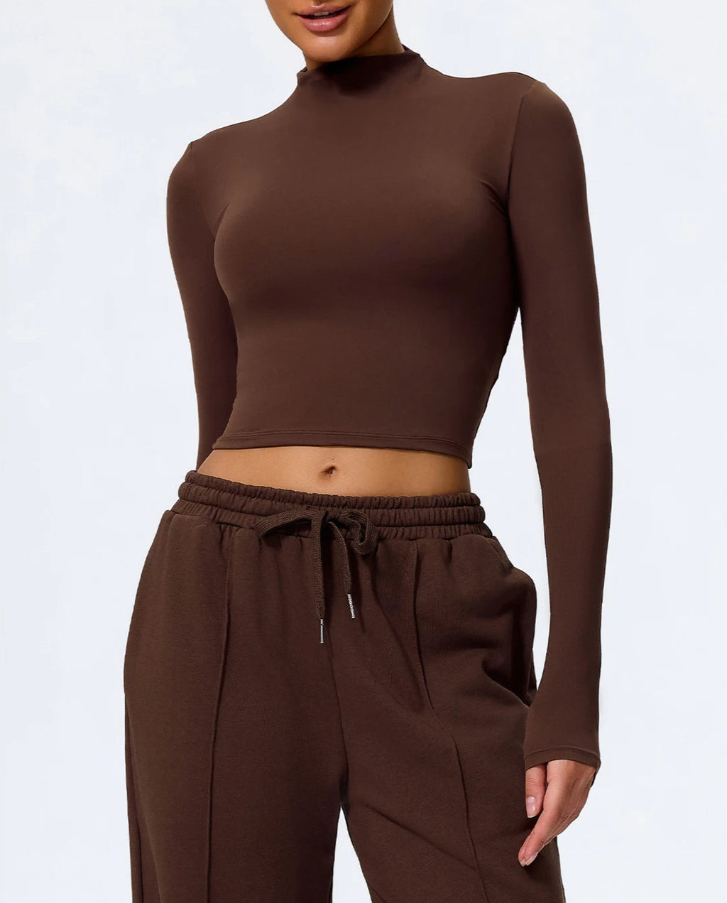 Brown long-sleeve top and pants set on a white background