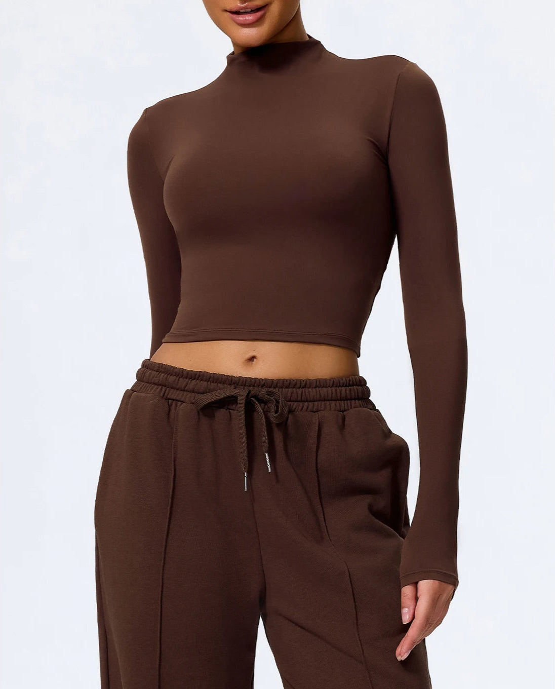 Brown long-sleeve top and pants set on a white background
