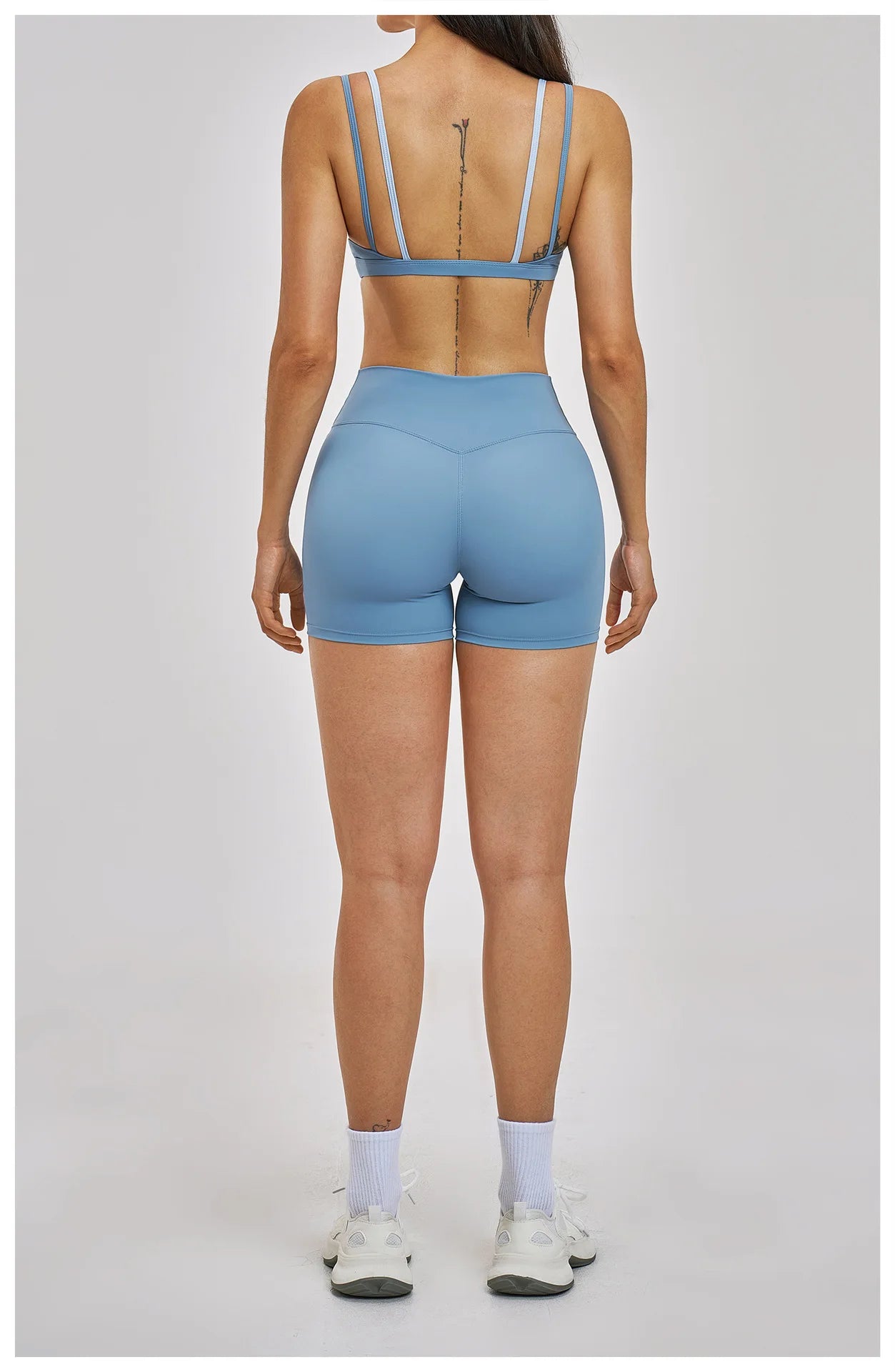 Person wearing a blue athletic outfit on a plain background
