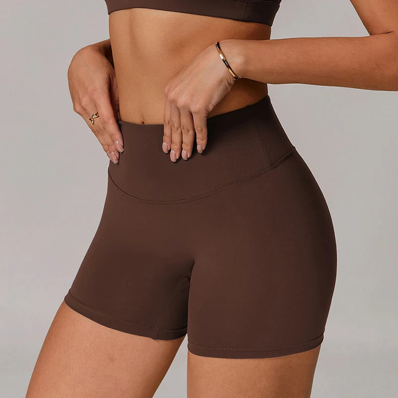 Brown athletic shorts worn by a person on a plain background