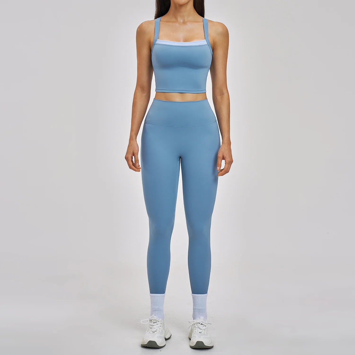 Person wearing a blue athletic outfit on a gray background