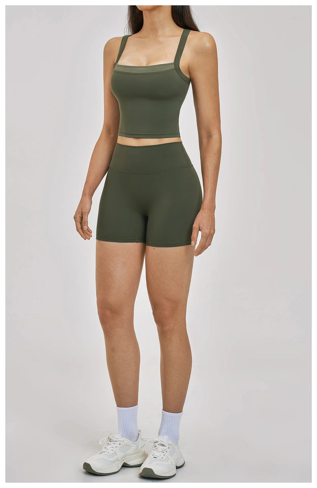 Person wearing a green athletic outfit on a plain background