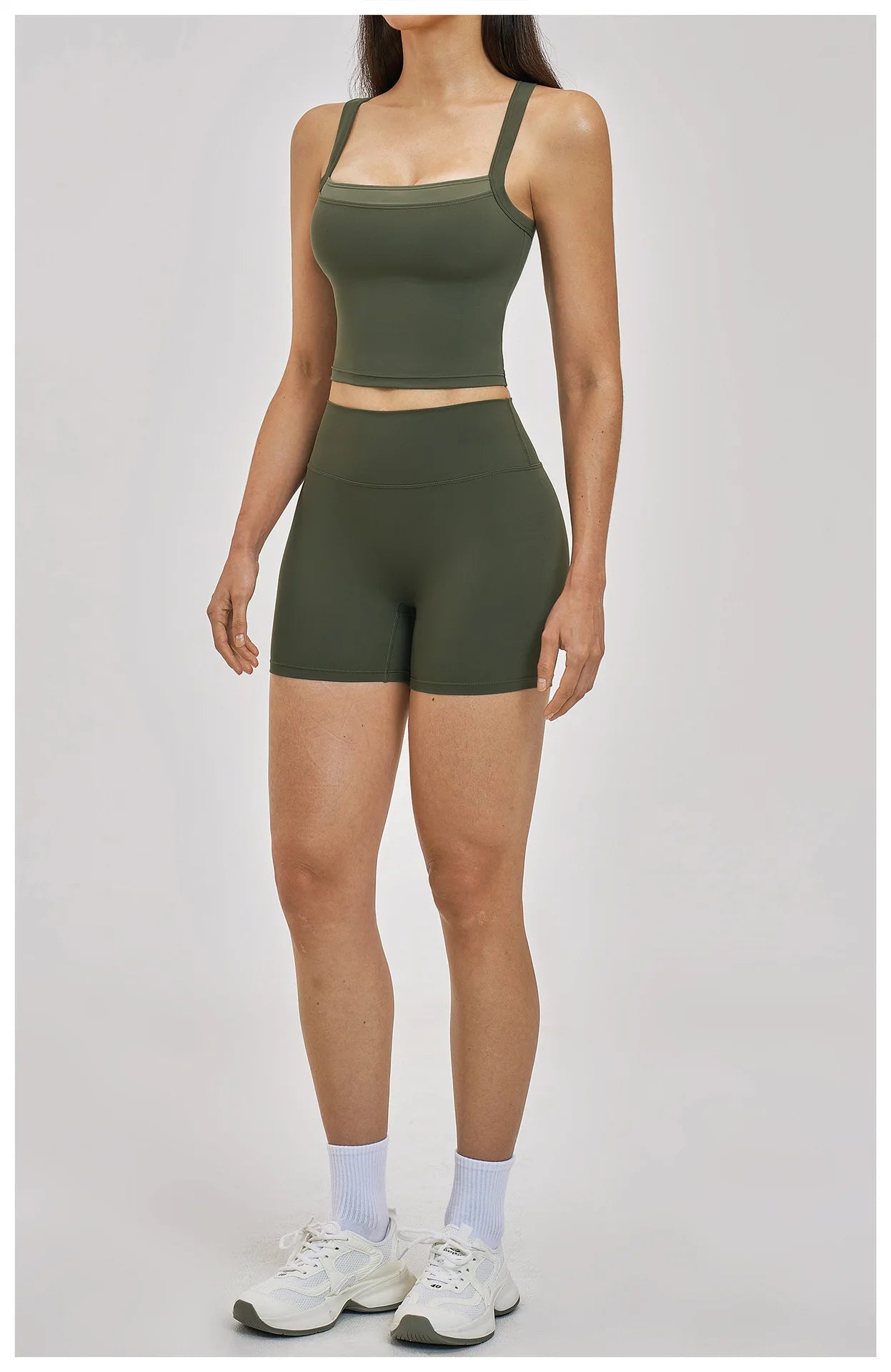 Person wearing a green athletic outfit on a plain background