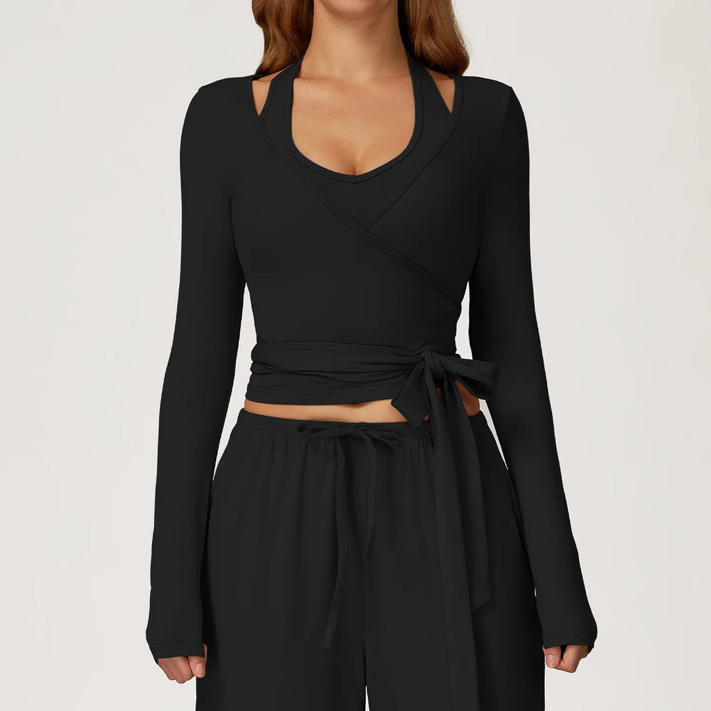 Black long-sleeve ballet wrap top and pants set on a plain background