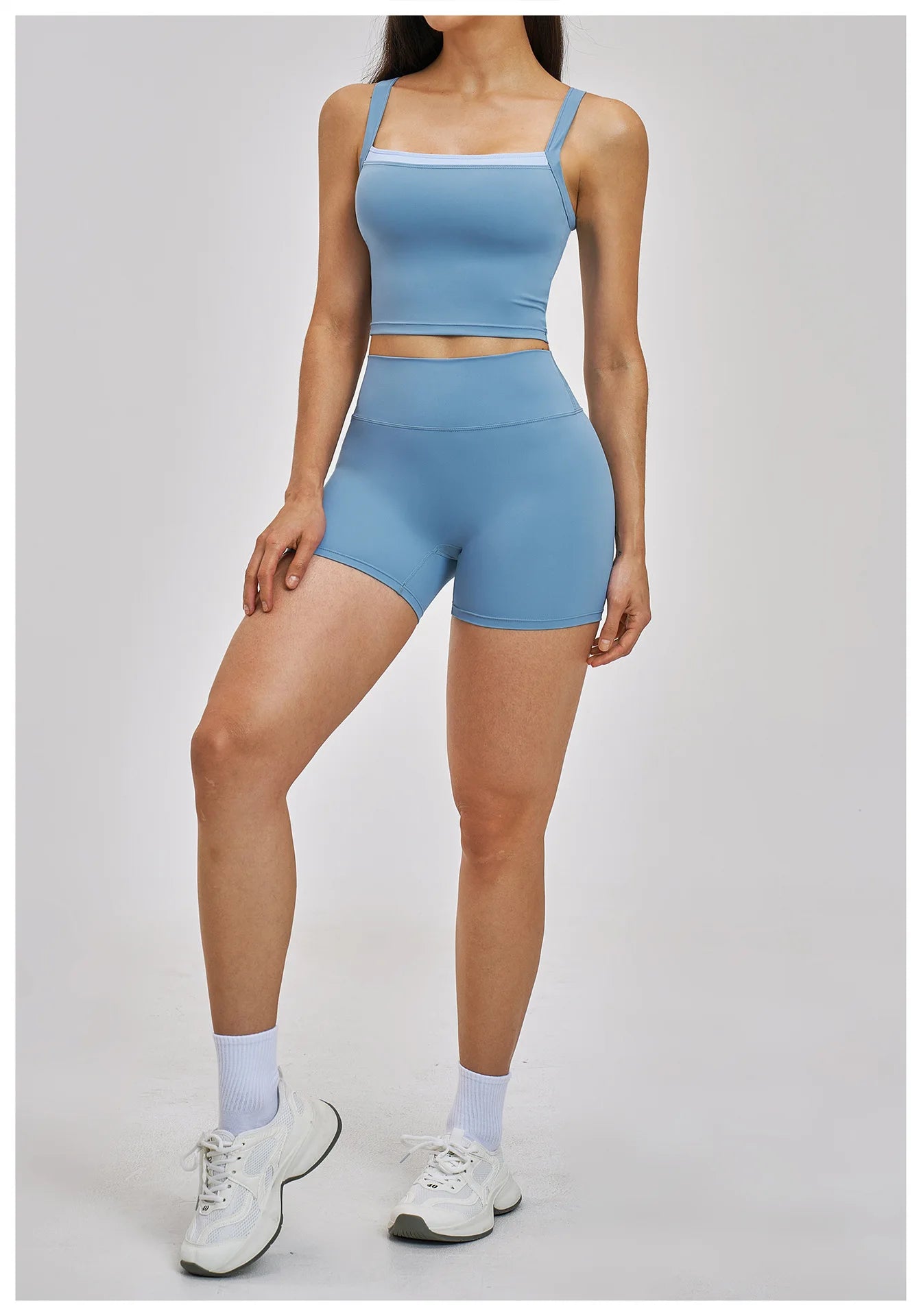 Person wearing a blue athletic outfit on a light gray background