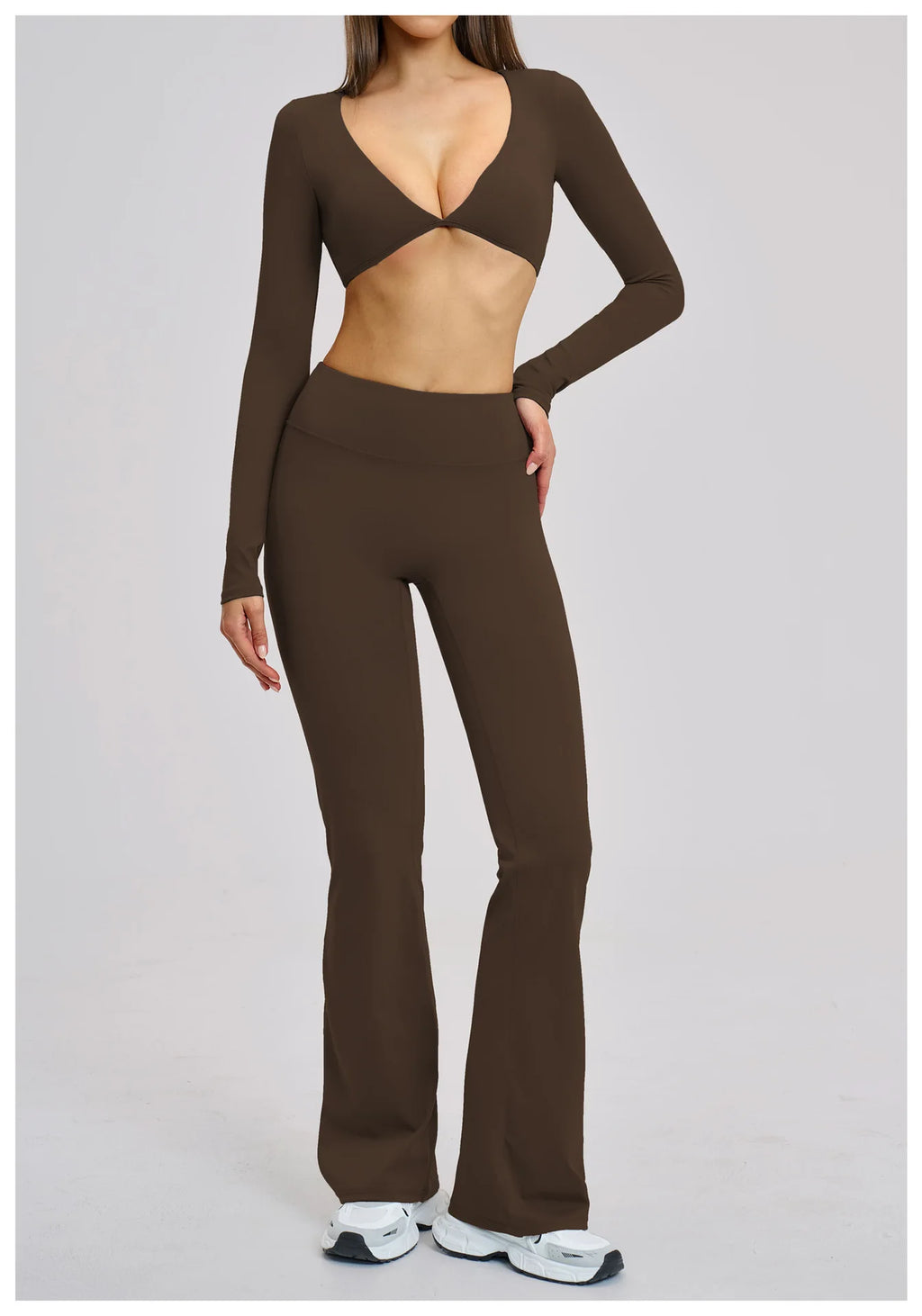 Brown long-sleeve top and flared pants on a plain background