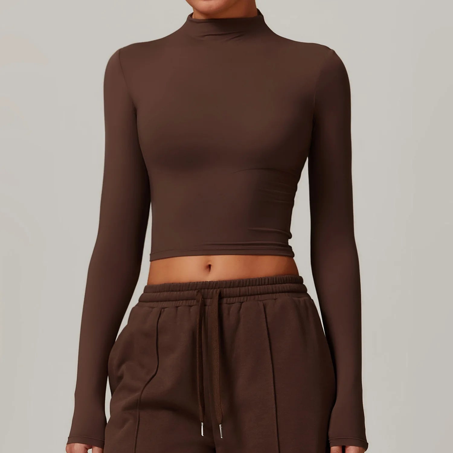 Brown long-sleeve top and pants on a neutral background