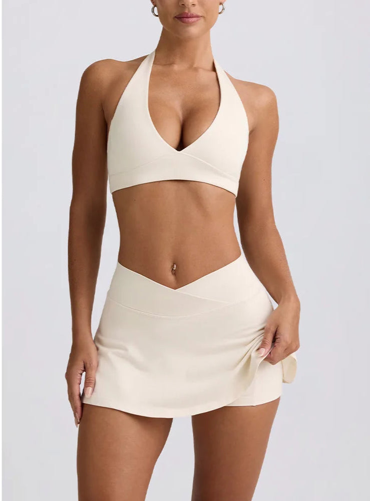 Woman wearing a beige bikini set on a light gray background