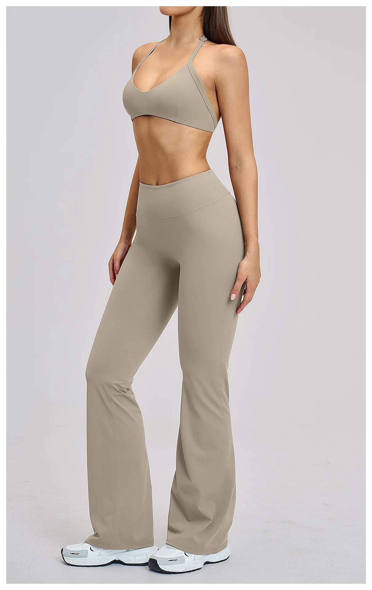 Person wearing a beige sports bra and leggings set on a light gray background