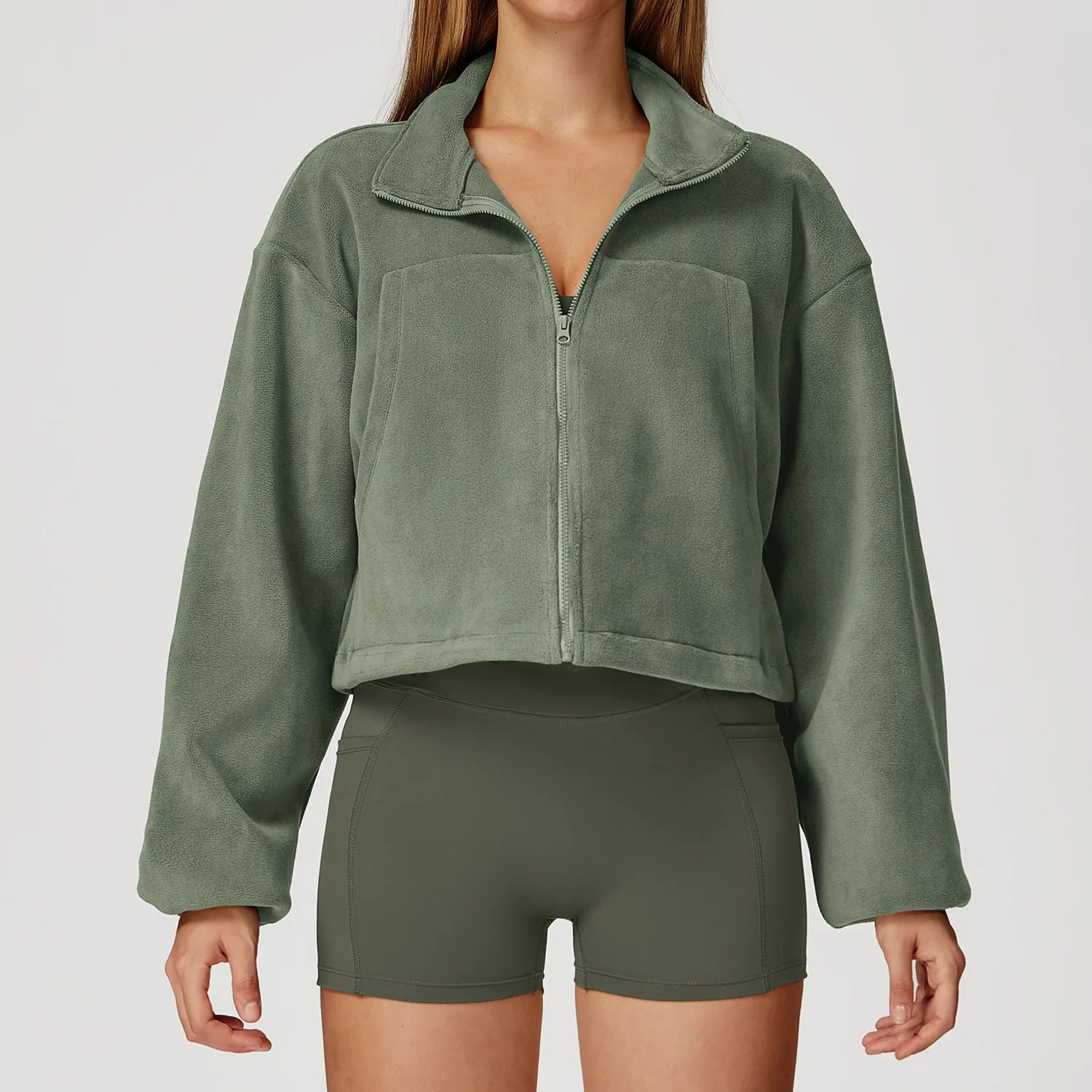 Green fleece jacket and shorts on a plain background