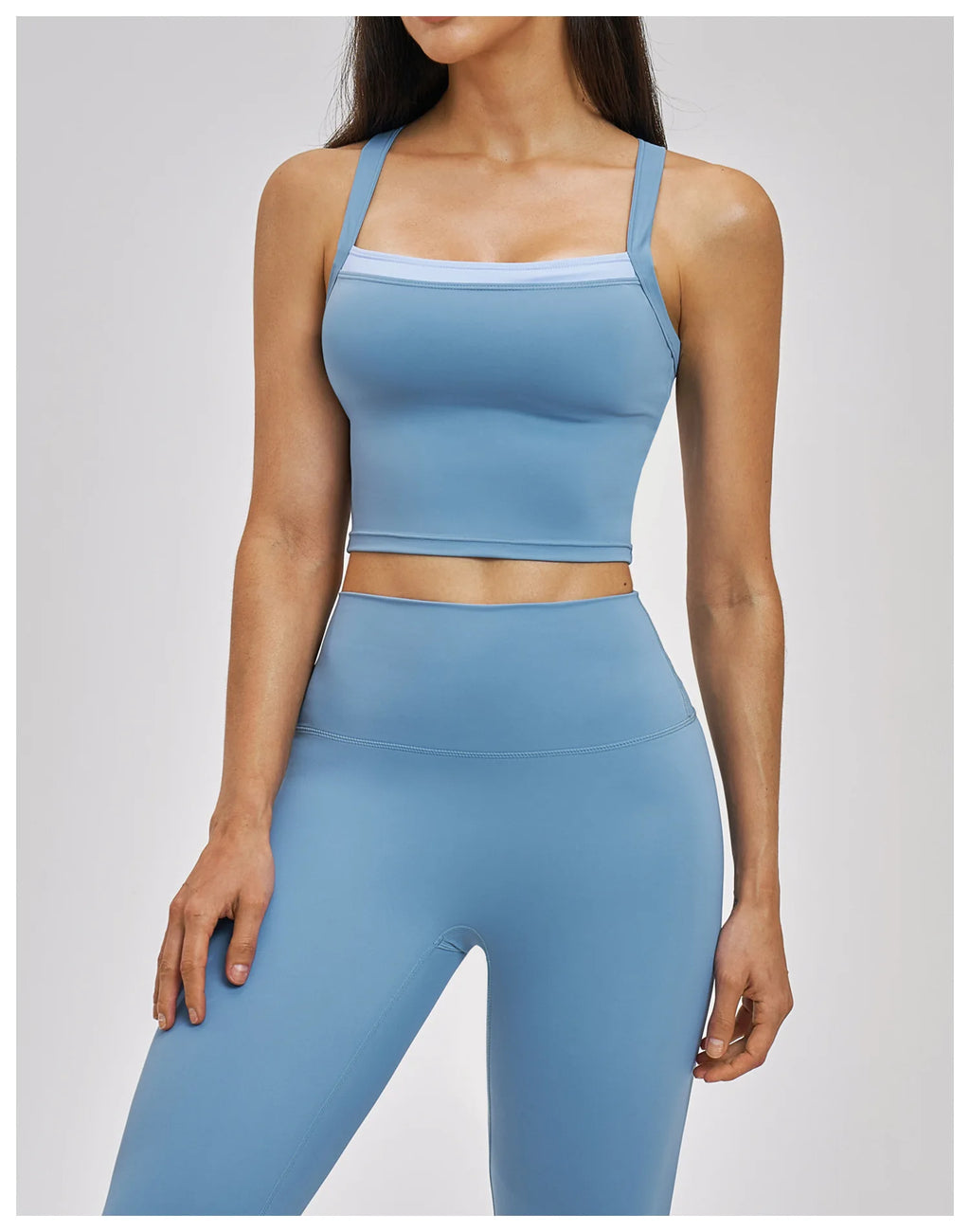 Woman wearing a blue athletic outfit on a light gray background