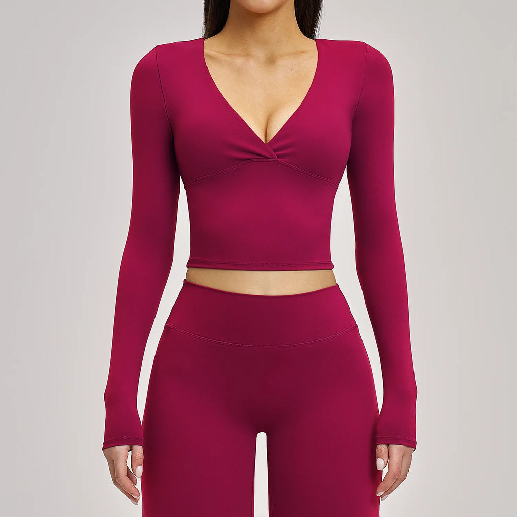 Maroon athletic top and leggings set on a plain background