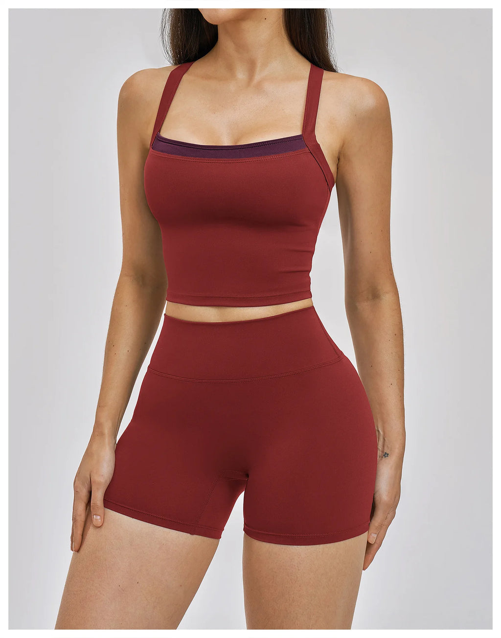 Red sports bra and shorts set on a plain background