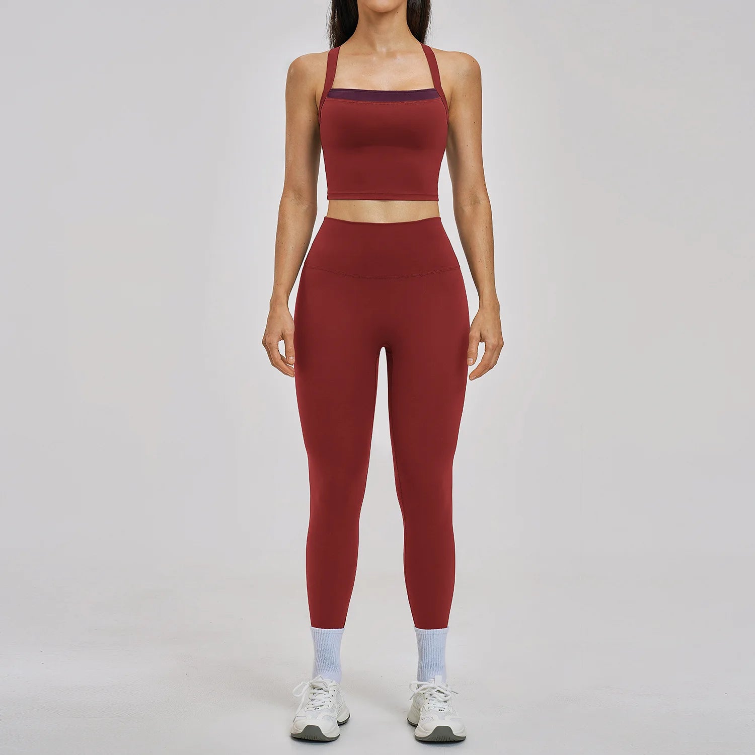 Person wearing a red athletic outfit on a gray background