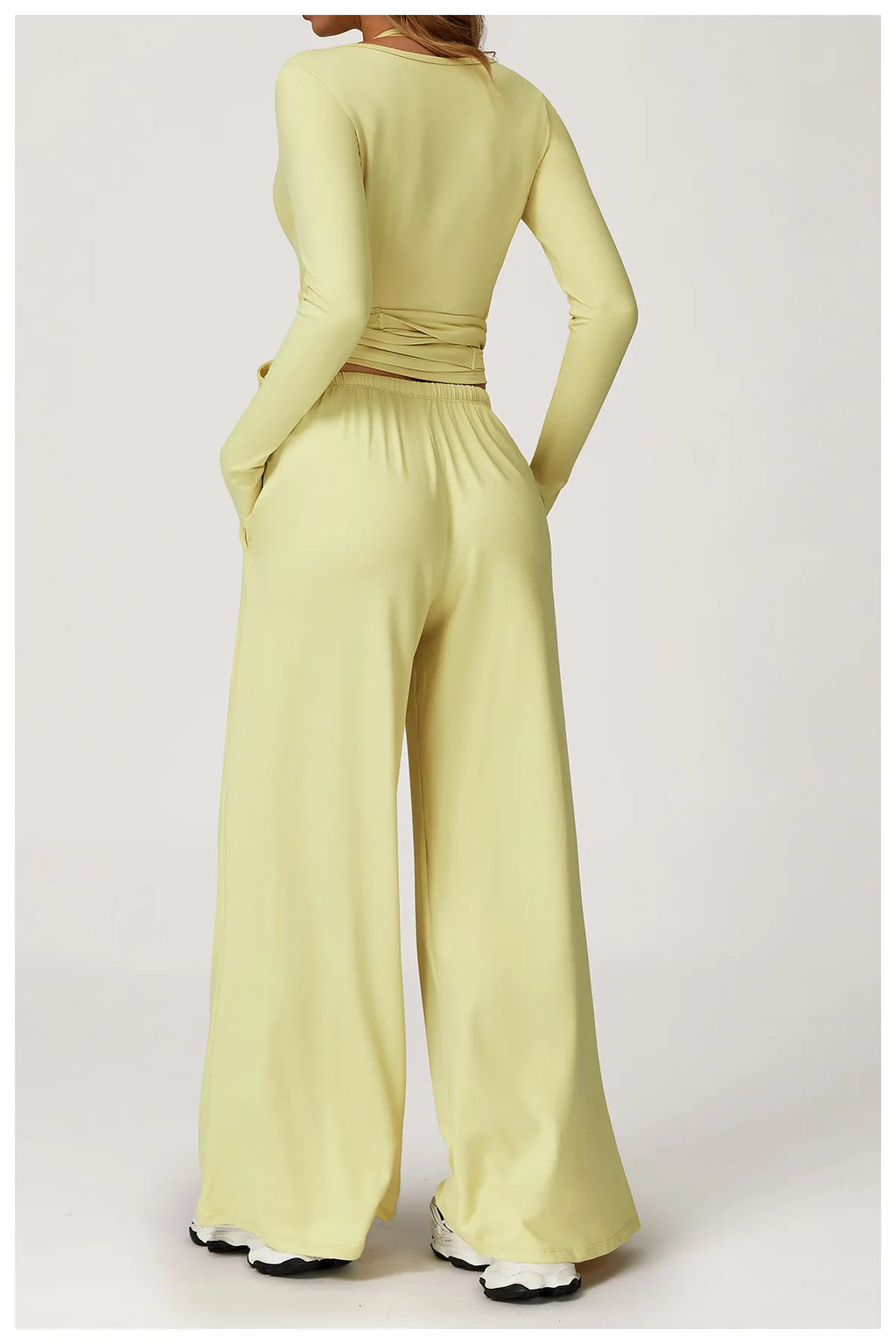 Light green ballet wrap top with wide-leg pants on a white background