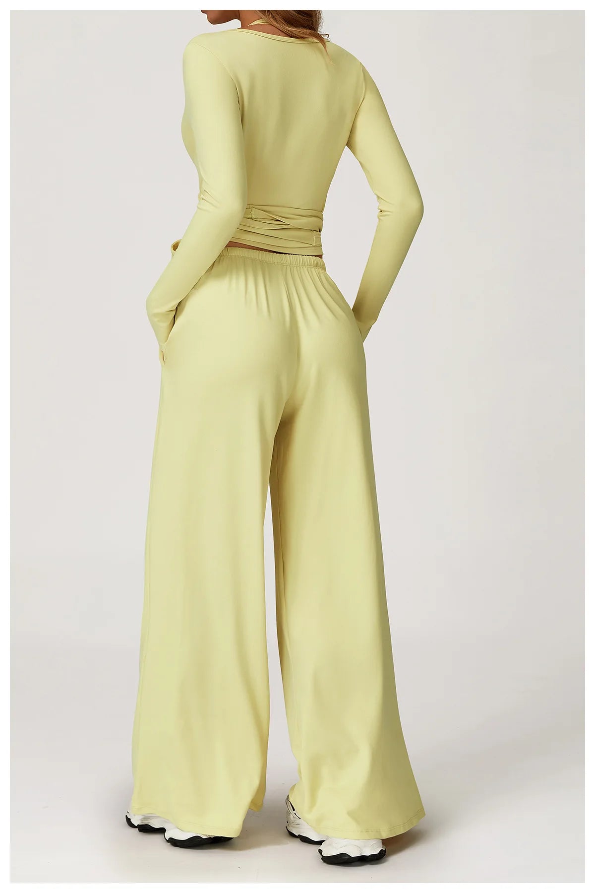 Light green ballet wrap top with wide-leg pants on a white background