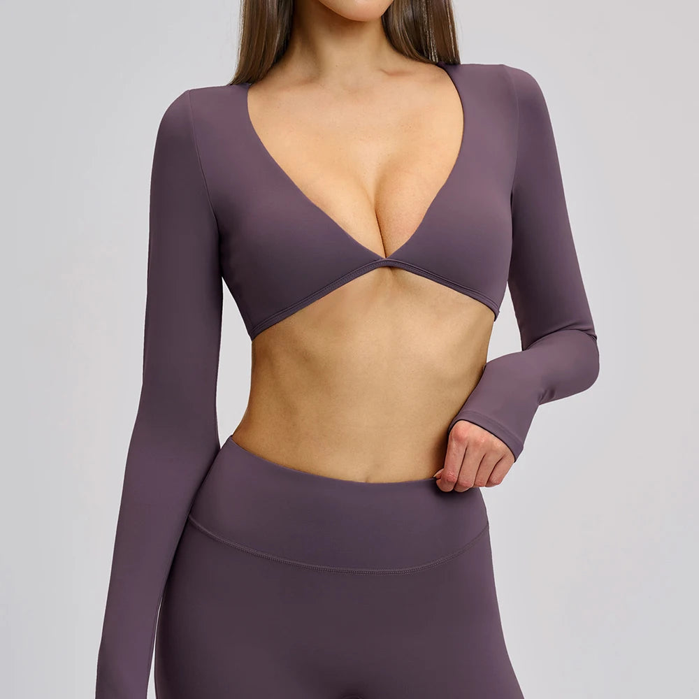 Purple long-sleeve top with cut-out design on a plain background