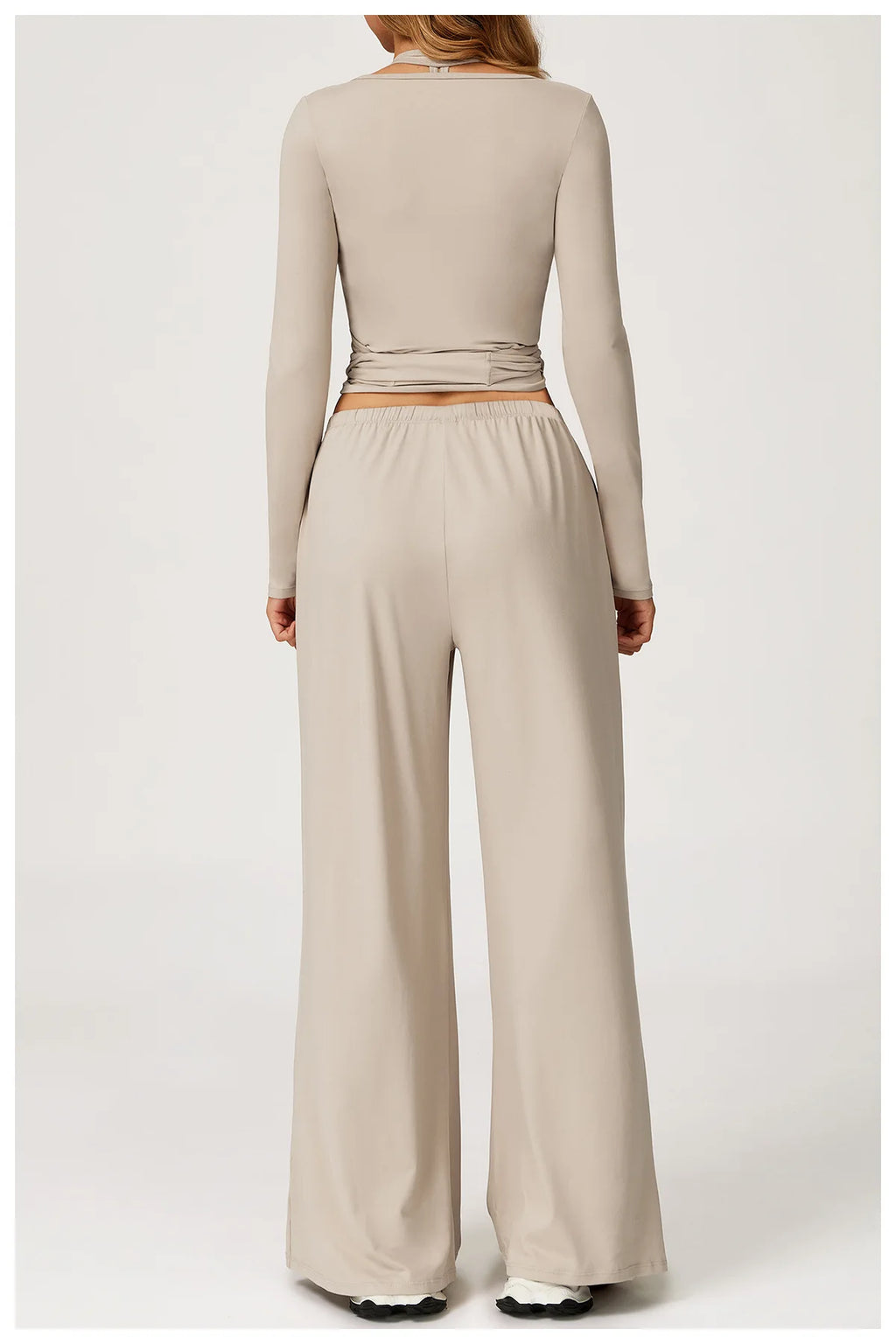 Beige long-sleeve top and wide-leg pants on a white background