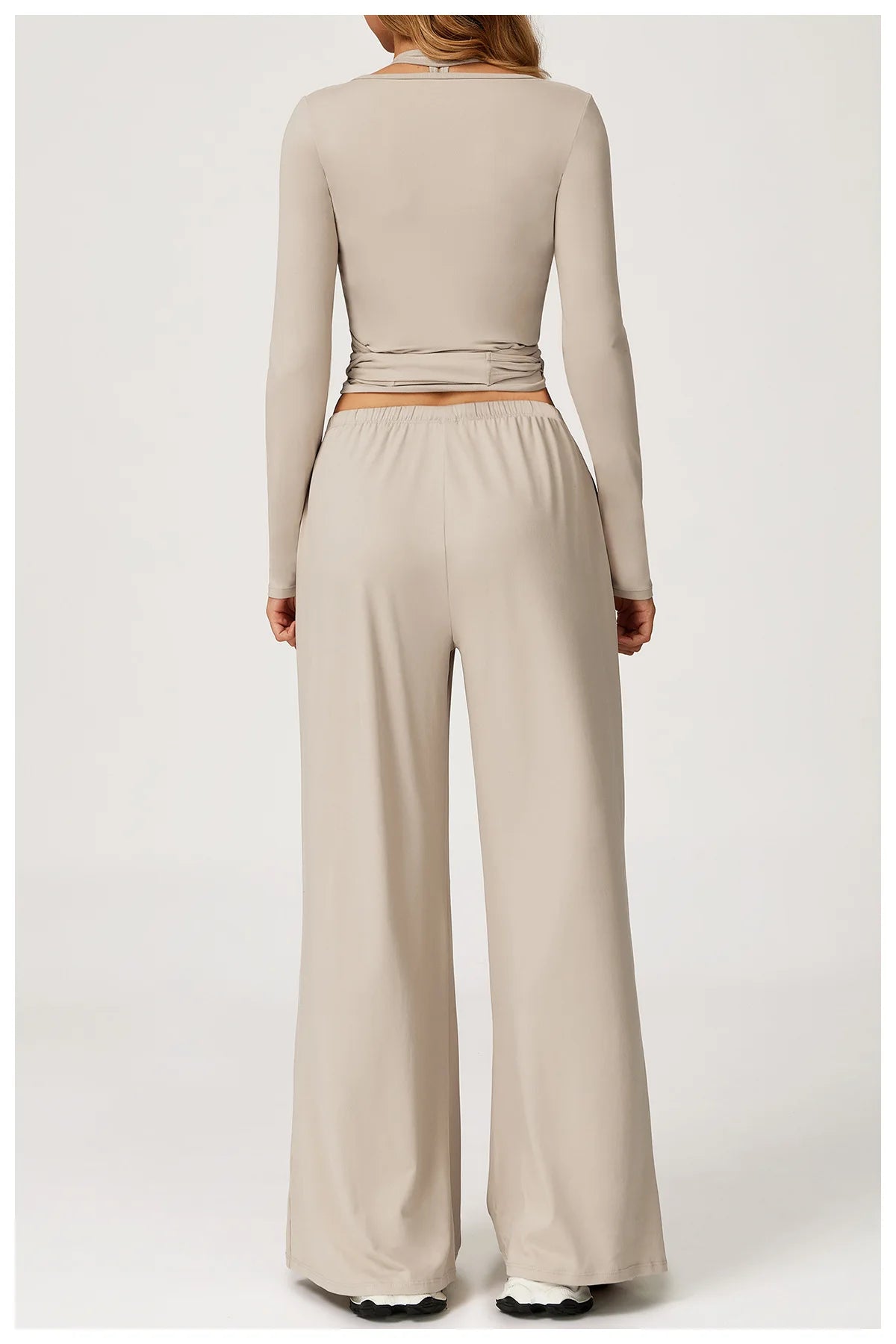 Beige long-sleeve top and wide-leg pants on a white background