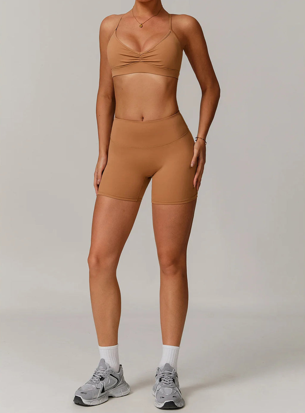 Person wearing a brown athletic outfit on a plain background