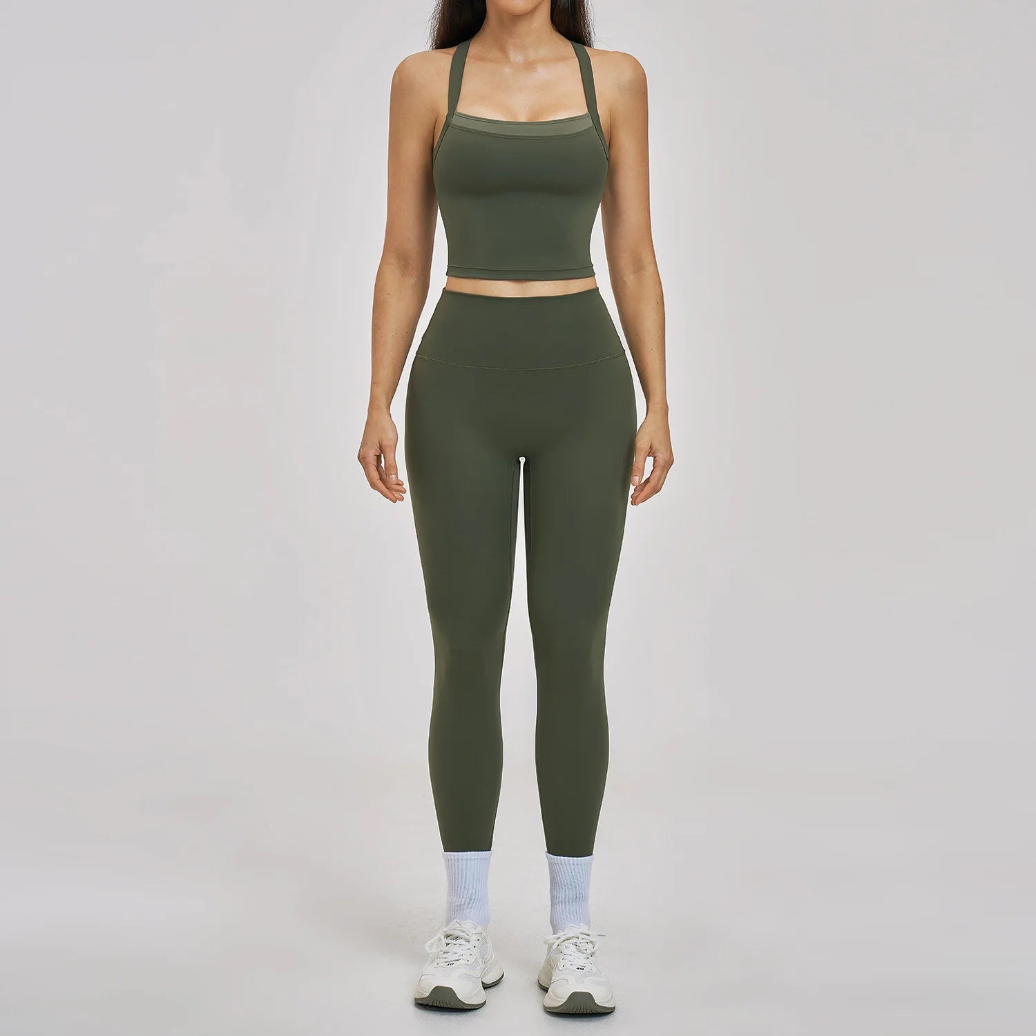 Person wearing a green athletic outfit on a plain background