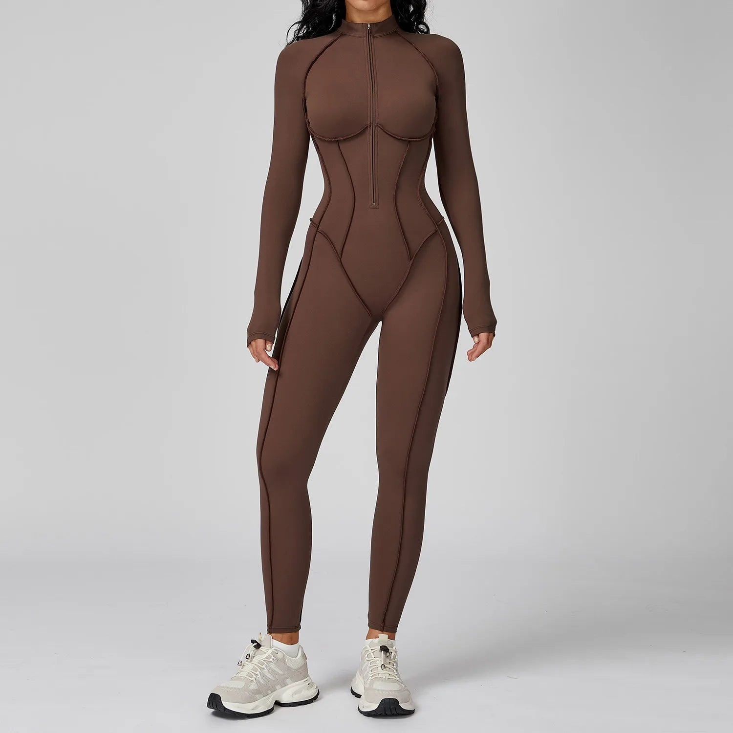 Person wearing a brown bodysuit on a gray background