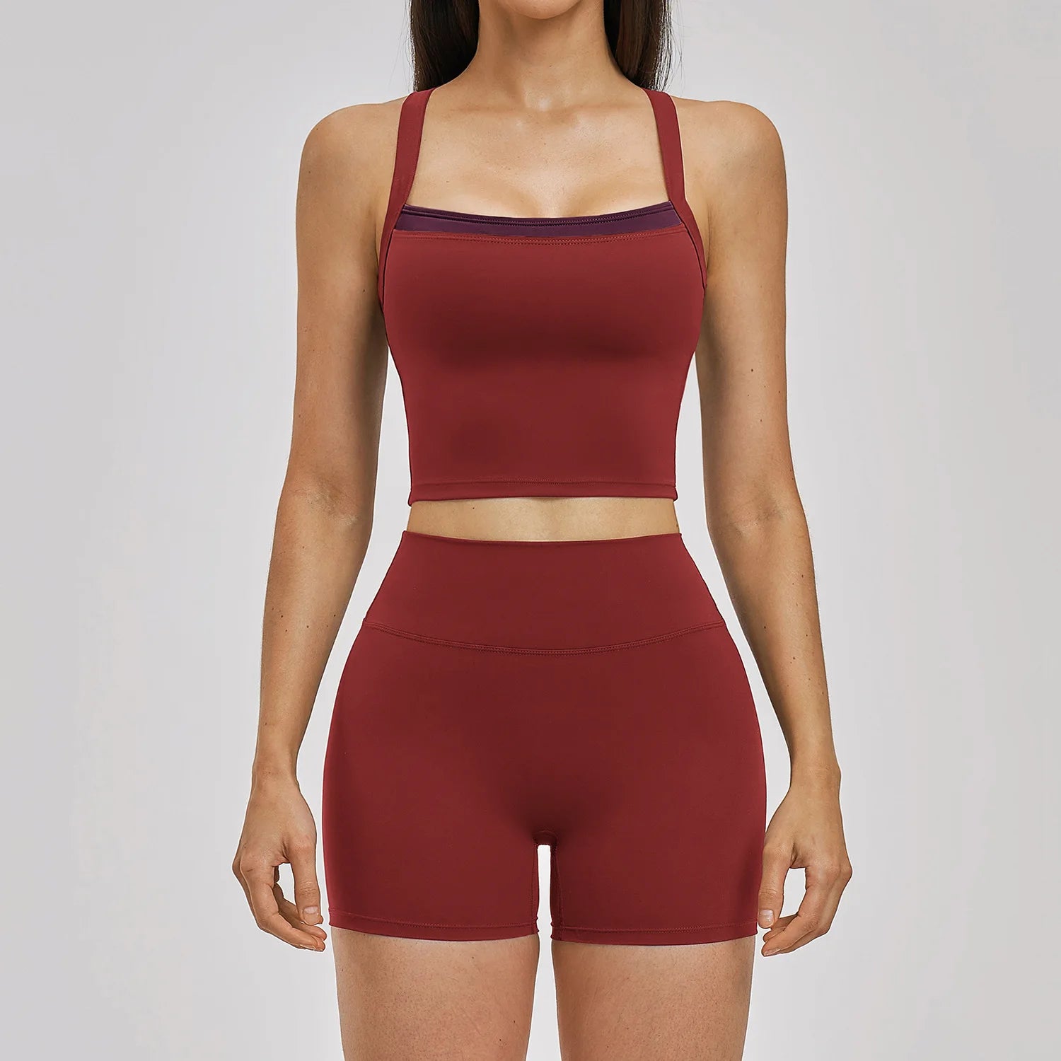 Red sports bra and shorts set on a plain background