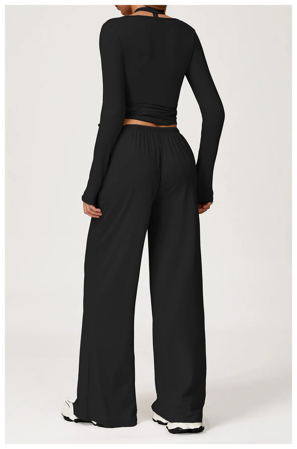 Black long-sleeve ballet wrap top and wide-leg pants on a white background