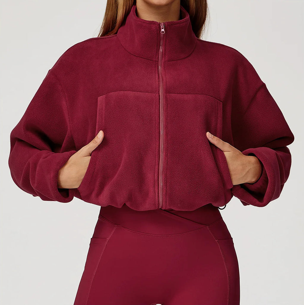 Maroon fleece jacket worn by a person on a white background