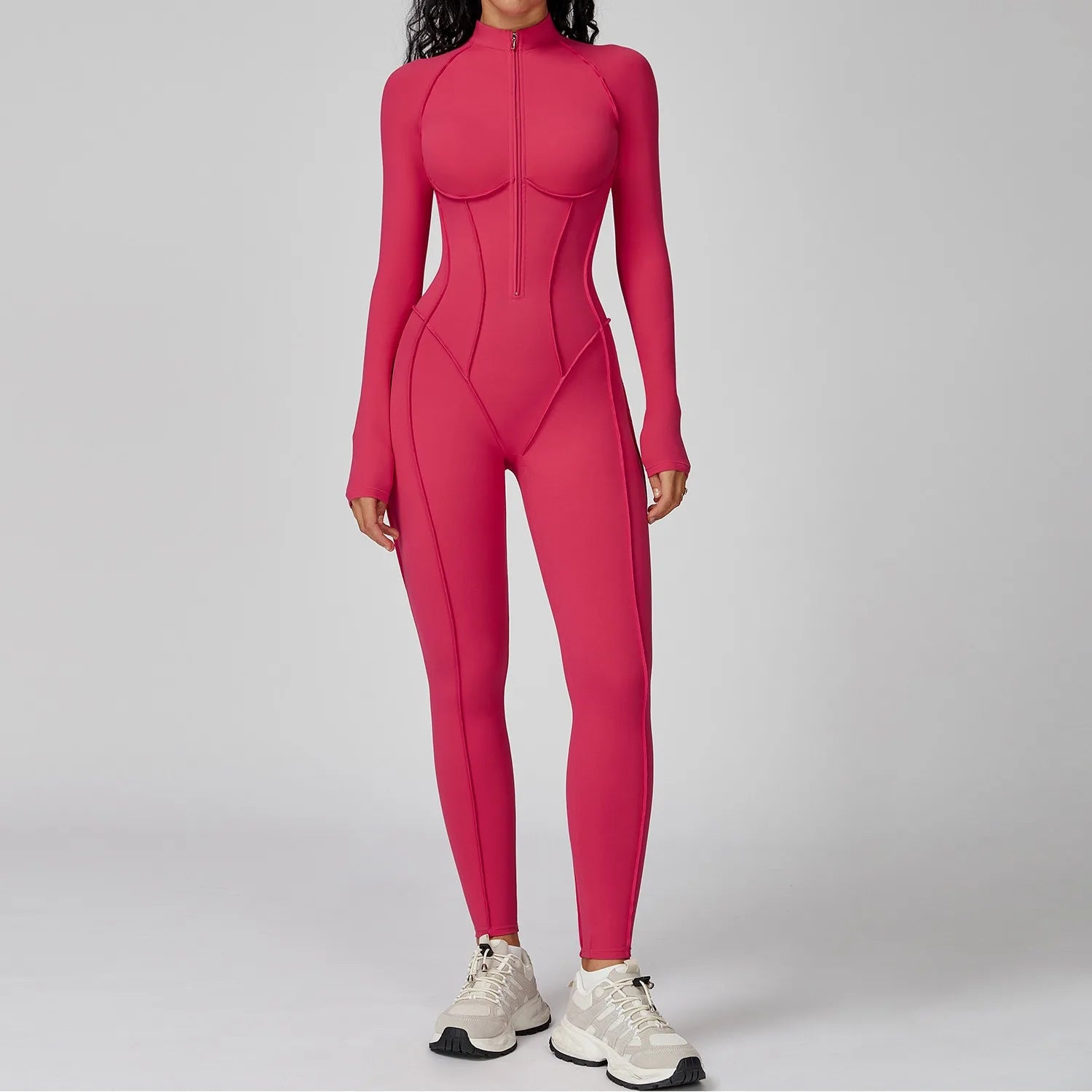 Person wearing a pink bodysuit on a gray background