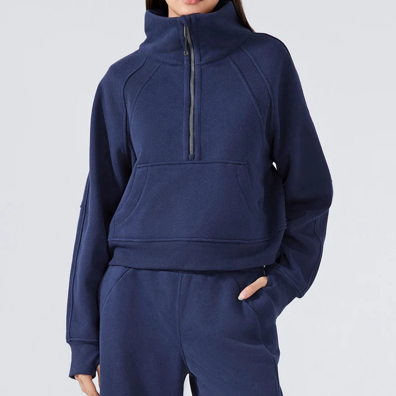 Navy blue tracksuit with a high collar on a light gray background