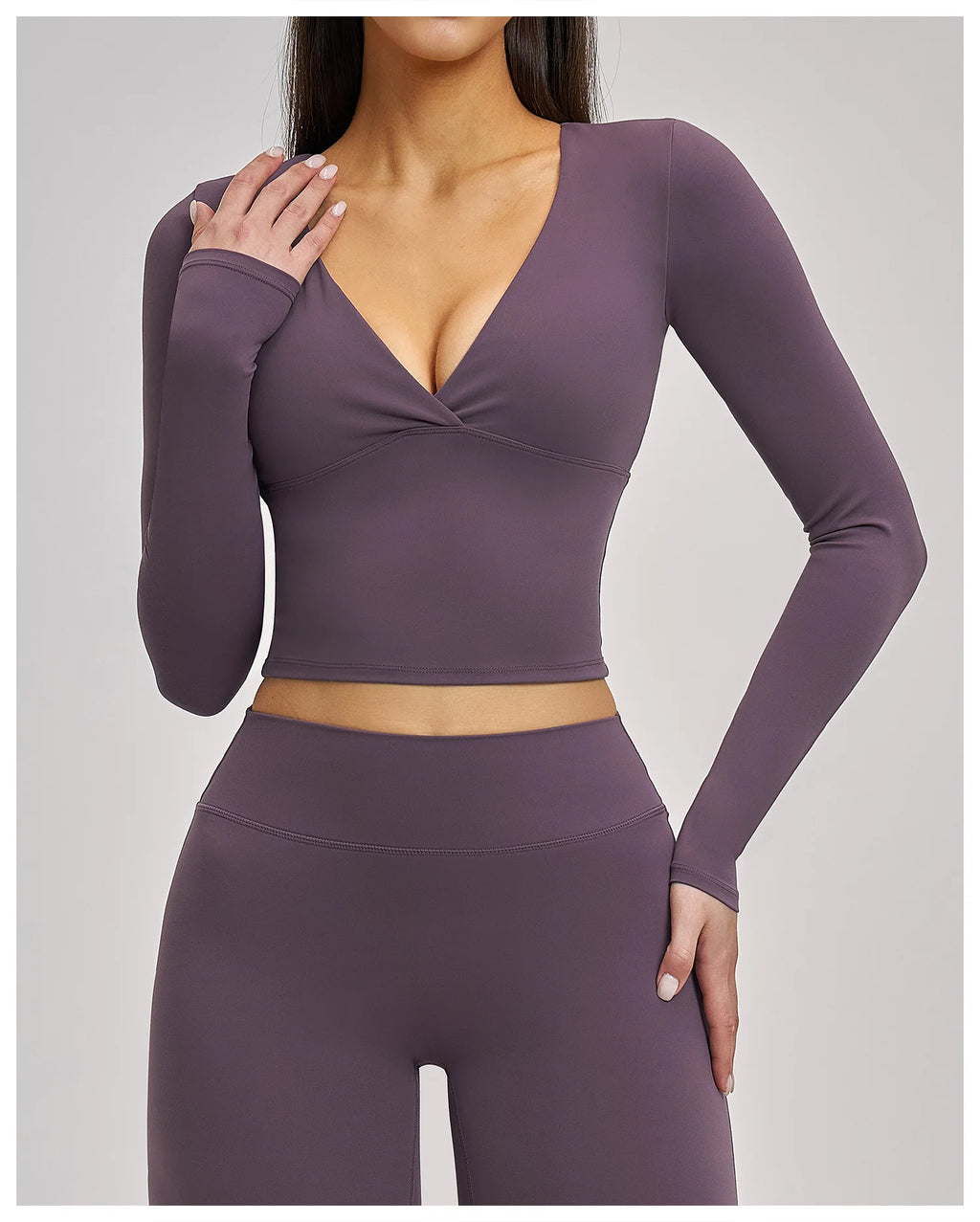 Purple long-sleeve top and leggings set on a plain background