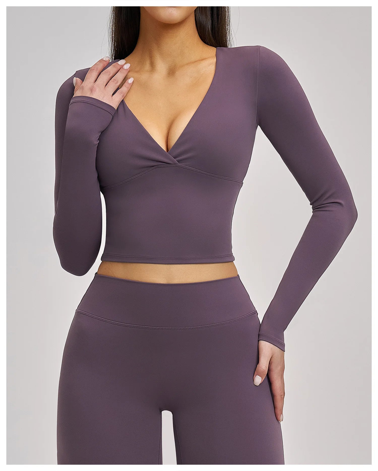 Purple long-sleeve top and leggings set on a plain background
